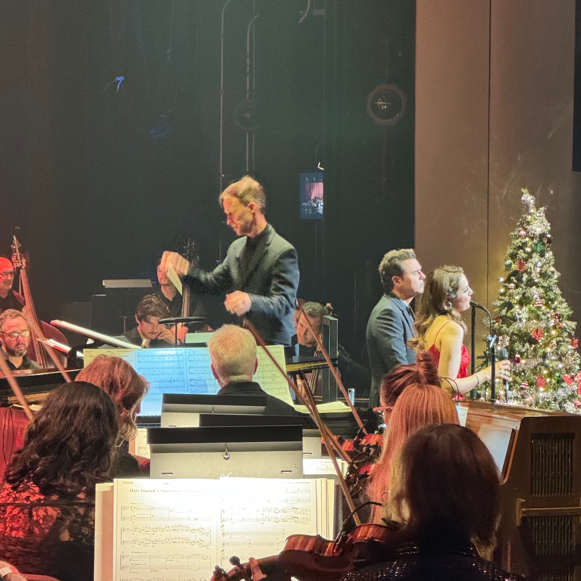 Andrew conducting Merriest Album (photo online on X)